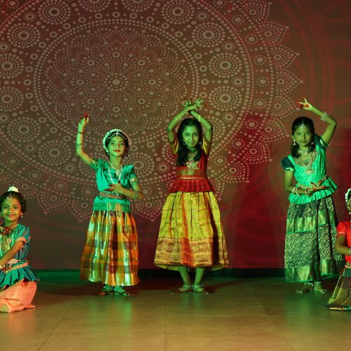 Children performing a traditional cultural dance at Waddle Kids Preschool annual celebration
