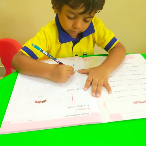 Children engaged at activity tables in Waddle Kids Preschool classroom, Chennai