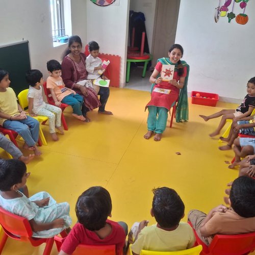 Storytime circle at Waddle Kids Preschool Sholinganallur — teacher reading to LKG children